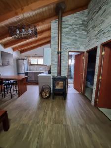 a living room with a wood stove in a room at Refugios de Montaña Reloncaví - Ruka Lee III in Nevados de Chillan