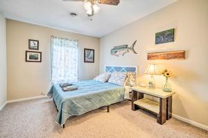 a bedroom with a bed and a table with a lamp at Pet-Friendly Wilmington Home with Fenced Yard! in Wilmington