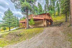 a house on a hill with a dirt road at Updated Ruidoso Cabin with Spacious Deck and View in Ruidoso