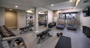 a gym with several treadmills and machines in a room at Marina del Rey Hotel in Los Angeles