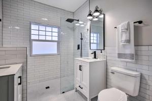 a white bathroom with a toilet and a shower at El Paso Historic Craftsman House Less Than 1 Mi to Dtwn! in El Paso +37 photos