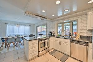 a kitchen with a table and a dining room at Modern Oceanside Home with Pool and Putting Green in Oceanside