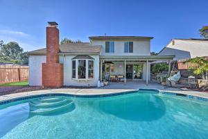 a swimming pool in front of a house at Modern Oceanside Home with Pool and Putting Green in Oceanside