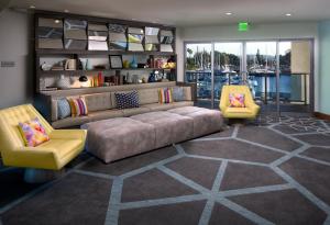 a living room with a couch and two chairs at Marina del Rey Hotel in Los Angeles