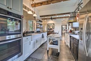 a large kitchen with white cabinets and stainless steel appliances at Picturesque Jefferson Abode with On-Site Pond! in Jefferson