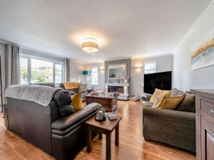 a living room with a couch and a tv at Y Lonydd in Ciliau-Aeron