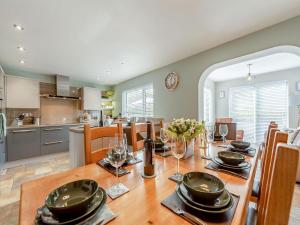 a kitchen and dining room with a wooden table and chairs at Y Lonydd in Ciliau-Aeron