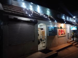 a store front with a closed door at night at Hill Inn Rooms an HomeStay in Ooty