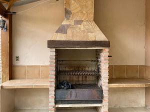 a brick oven with a dog sitting in it at Agradable departamento - casa con estacionamiento gratis in Sucre