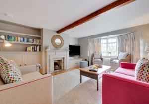 a living room with two couches and a fireplace at 6 North Green in Southwold