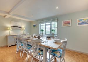 a large dining room with a table and chairs at 6 North Green in Southwold