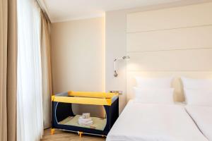 a small bedroom with a bed and a yellow and blue shelf at NH Berlin Alexanderplatz in Berlin