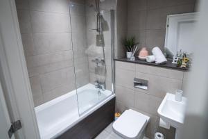 a bathroom with a tub and a toilet and a sink at Kelham Gate 1-Bed Apartments - City Centre - New - FREE Wi-Fi in Sheffield