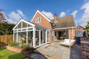 an extension to a house with a conservatory at Ashtree House in Barton on Sea