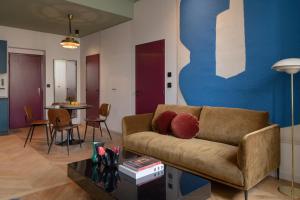 a living room with a couch and a table at MiHotel Blandan in Lyon