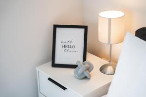 a bedroom with a bedside table with a picture and a lamp at Central Studio - New - FREE Wi-Fi - City Centre in Sheffield