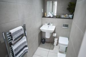 a bathroom with a sink and a toilet at Central Studio - New - FREE Wi-Fi - City Centre in Sheffield