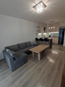 a living room with a couch and a table at Apartament Parkowa in Olecko