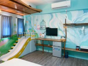 um quarto para crianças com um escorrega e uma secretária em 田中歐寒集b&b em Dongshan