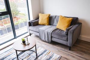 a living room with a couch and a table at The Interchange - 2-Beds - Brand New - Central in Manchester