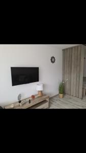 a living room with a flat screen tv on a wall at Apartament 2B-5 Żarnowska in Żarnowska