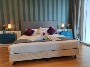 a bedroom with a bed with a teddy bear on it at Platinum Suites Klcc by Signature Apartment in Kuala Lumpur
