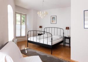 a bedroom with a bed and a chandelier at Hotel Obertor in Ravensburg