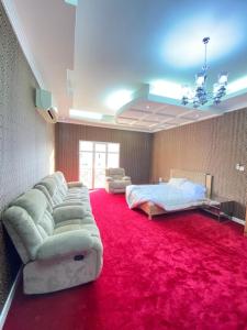 a living room with a couch and a red carpet at Pool and Steam room House in the heart of Muscat in Muscat