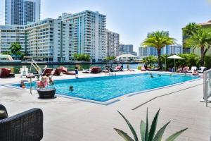 a swimming pool in a city with buildings at Cozy 1BR Condo Beachwalk Resort in Hallandale Beach