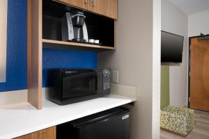 a microwave oven sitting on a shelf in a room at Holiday Inn Express & Suites San Antonio - Downtown Market Area, an IHG Hotel in San Antonio