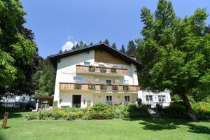 a building with a balcony on the side of it at Pension Seiwald in Kötschach Kärnten in Kötschach