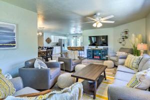 a living room with couches and a table at Merritt Island Oasis with Pool about 7 Mi to Beach! in Merritt Island