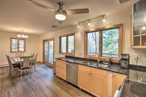 a kitchen with a sink and a table with chairs at Family-Friendly Woodbury Home with Yard and Deck! in Woodbury