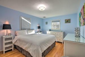 a bedroom with blue walls and a bed and a desk at Family-Friendly Woodbury Home with Yard and Deck! in Woodbury