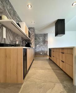 uma cozinha com armários de madeira e uma bancada em 5-star apartment em Gliwice