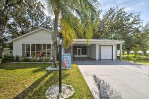 a palm tree in front of a house at Inviting Lady Lake House In the Village! in Lady Lake