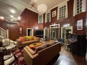 a living room with a couch and a piano at heritage style cottage by the lake in Orillia