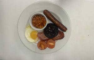 a plate of food with sausage beans beans and eggs at Smithton Hotel in Inverness