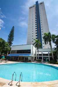 a large swimming pool in front of a tall building at Hotel Barranquilla Plaza in Barranquilla