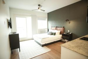 a bedroom with a white bed and a window at Baymont by Wyndham Fort McMurray in Fort McMurray