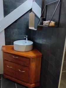 a bathroom with a sink on top of a wooden cabinet at La Maïta in Montgenèvre