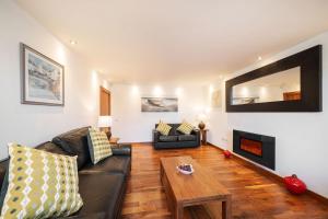a living room with a couch and a table at The Shore Apartment in Queensferry