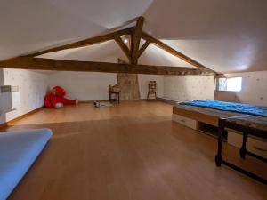 a large room with a bed and a wooden floor at Gîte familial avec piscine, jardin clos, équipements bébé, animaux acceptés, Chadurie - FR-1-653-61 in Chadurie +27 photos