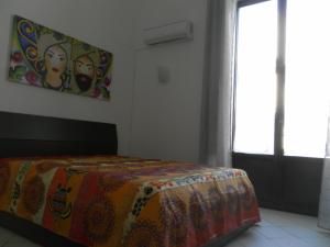 A bed or beds in a room at Casa Catania Inn
