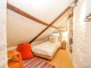 a small room with a bed in a attic at Manor Farm House in Norwich