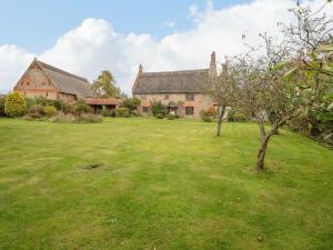 an old brick house with a large grass yard at Manor Farm House in Norwich