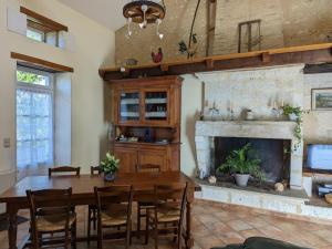 a dining room with a table and a fireplace at Gîte de charme avec jardin, proche d'Aubeterre-sur-Dronne, pour 6 pers., cheminée, WIFI, équipements bébé - FR-1-653-116 in Bellon +19 photos