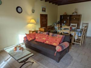 a living room with a couch and a table at Gîte Charentais avec Terrasse, Jardin et Randonnées - Idéal Familles et Animaux Acceptés - FR-1-653-177 in Salles-Lavalette