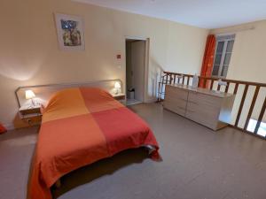 a bedroom with a bed and a dresser and a staircase at Gîte Charentais avec Terrasse, Jardin et Randonnées - Idéal Familles et Animaux Acceptés - FR-1-653-177 in Salles-Lavalette