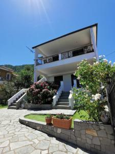 a house with stairs and flowers in front of it at DeniaStella Apartments in Skala Potamias
